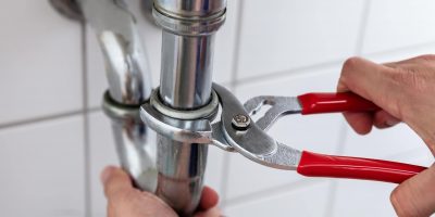 photo-of-a-professional-plumber-repairing-sink-min